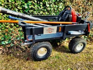 landscaping tools loaded into an electric wireless all terrain utility cart